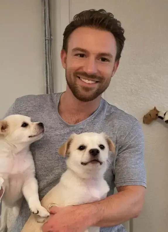 A man with puppies